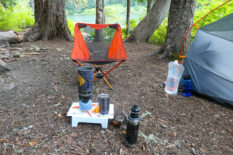 A camping equipment in the woods

Description automatically generated