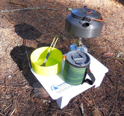 A kettle and a pot on a stove

Description automatically generated