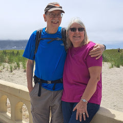 A person and person standing on a bridge

Description automatically generated